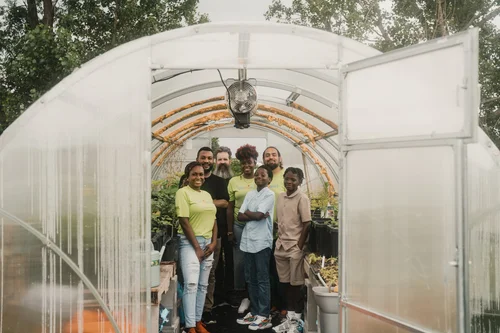 several people in a greenhouse